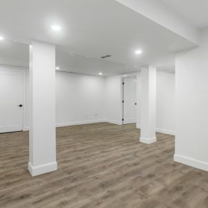 an empty room with white walls and wooden floors
